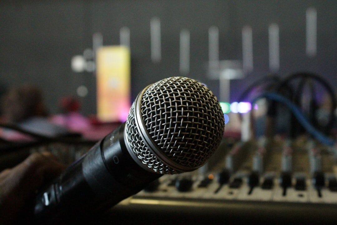 Professional studio microphone with broadcast mixing console in background